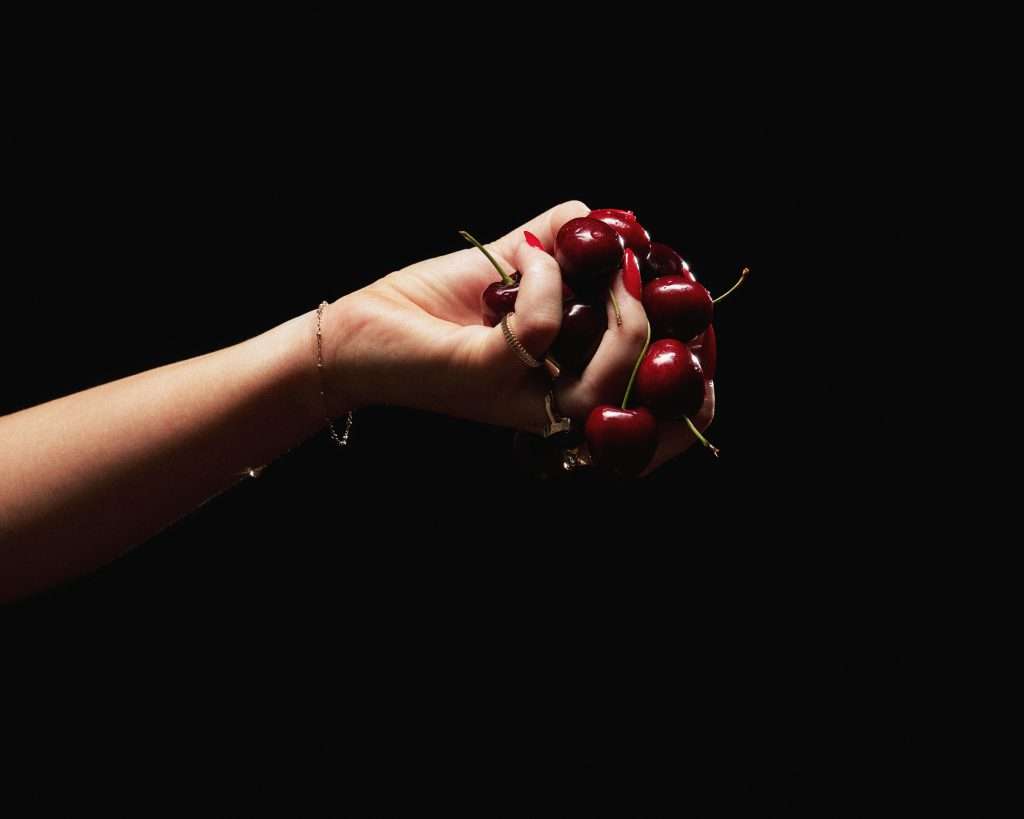 Hand holding cherries