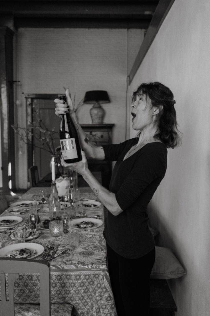 Woman opening bottle of wine